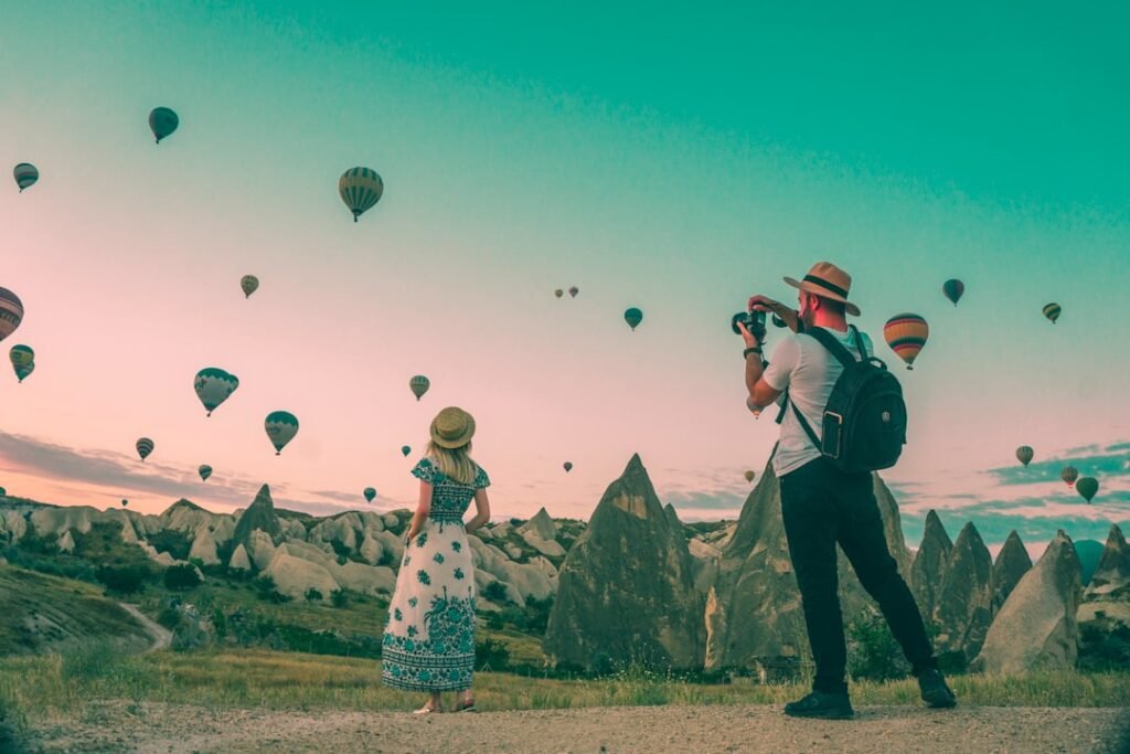 man taking photo of hot air balloons eocyhe5 9sq